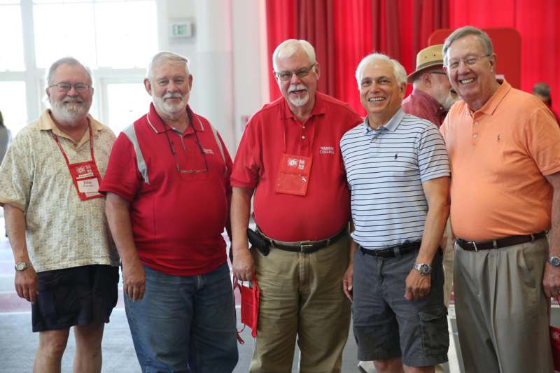 a group of older men standing together