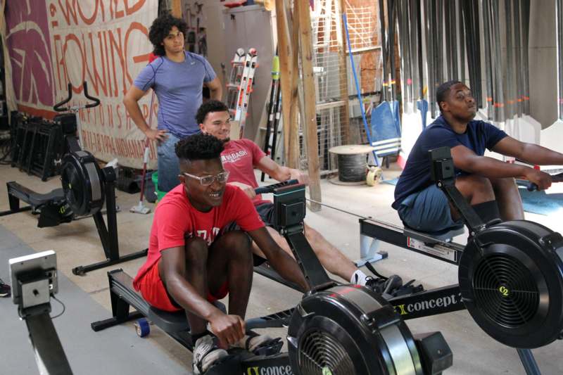 a group of men on rowing machines