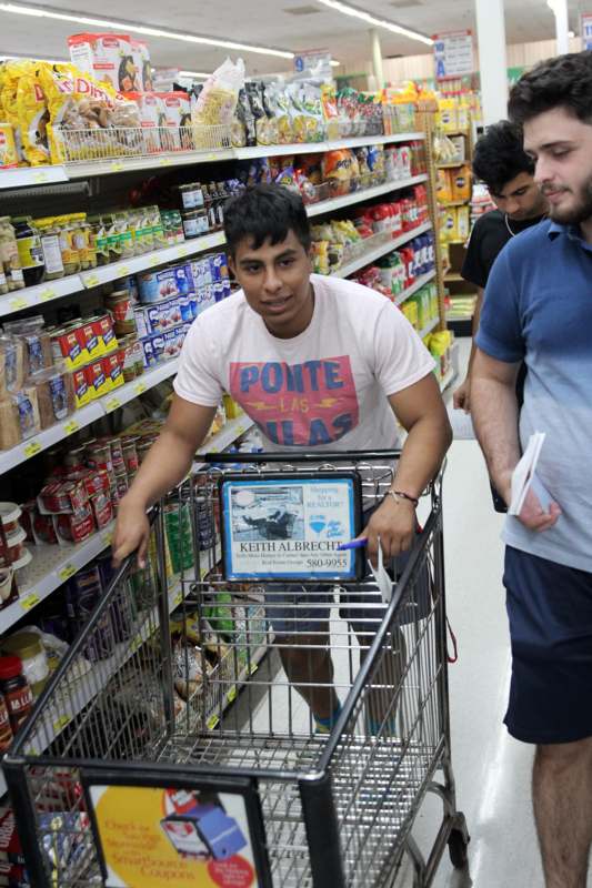 a man pushing a shopping cart in a store