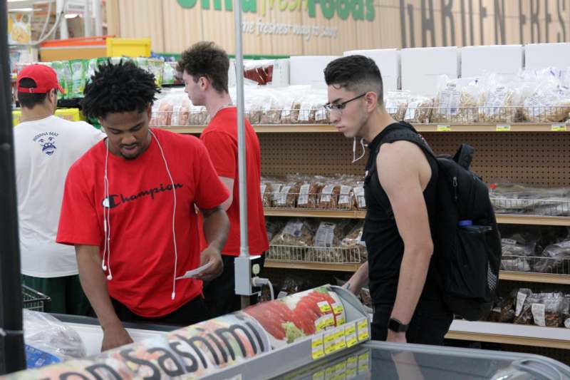 a group of men in a grocery store