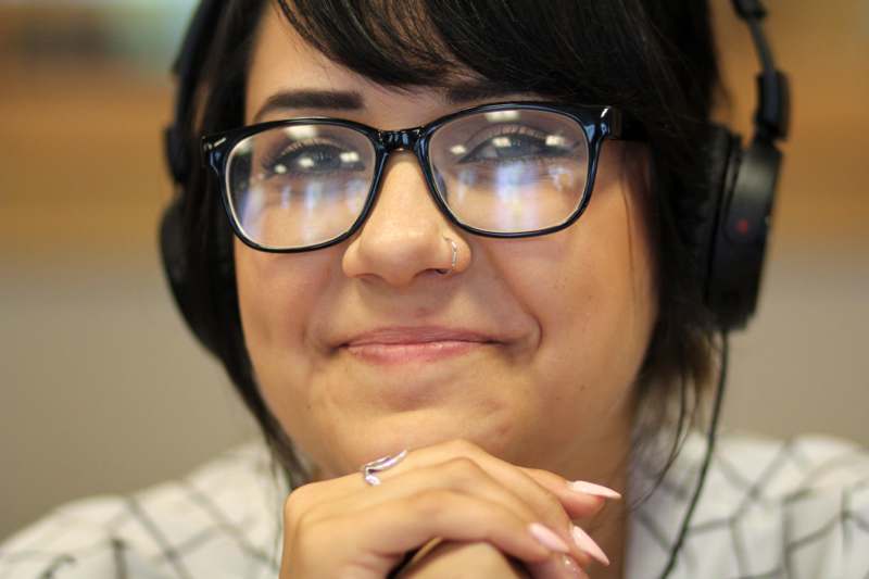 a woman wearing glasses and headphones
