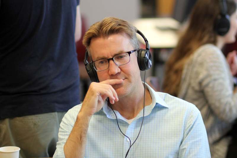 a man wearing headphones and touching his chin