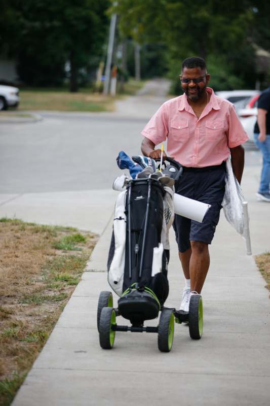 a man pushing a golf cart