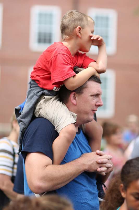 a man carrying a child on his shoulders