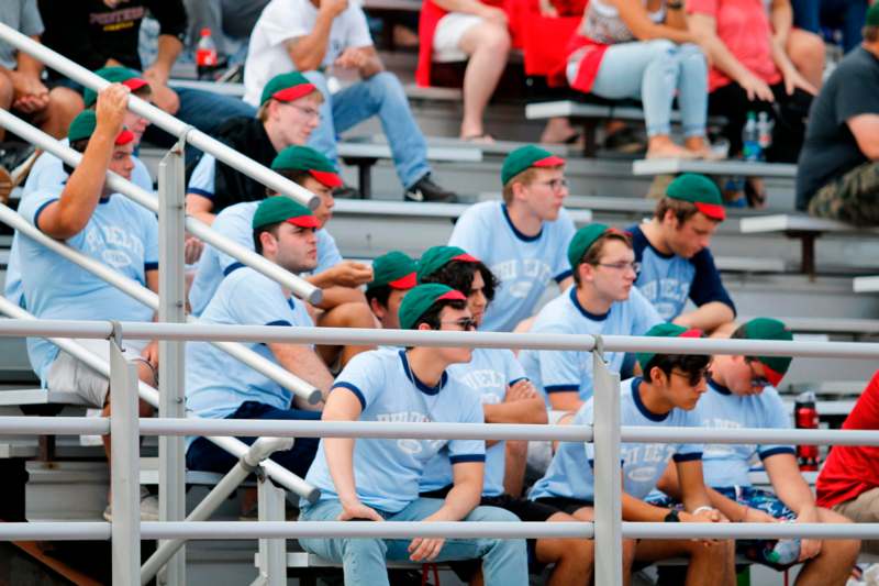 a group of people sitting in bleachers
