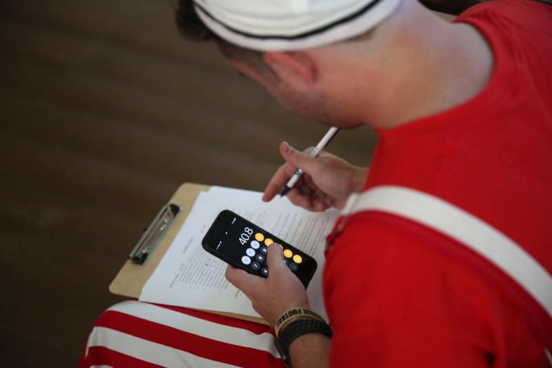 a man holding a pen and a phone