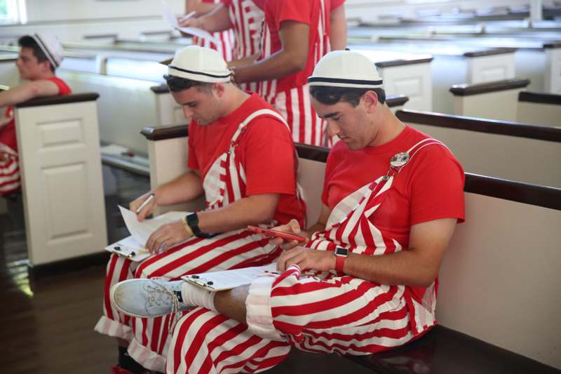 a group of men in red and white striped overalls