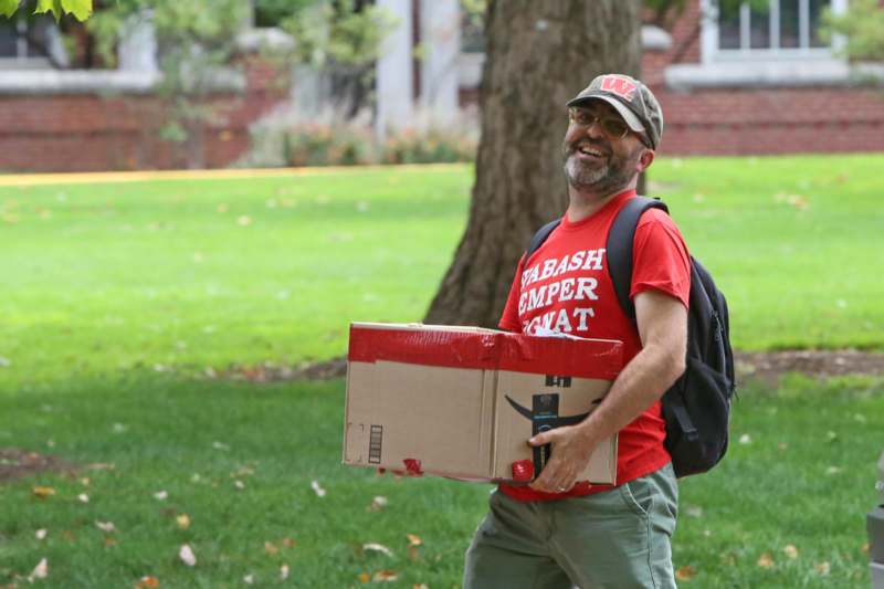 a man carrying a box