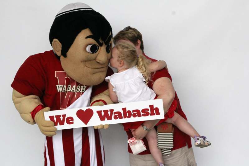 a person with a child kissing a sign