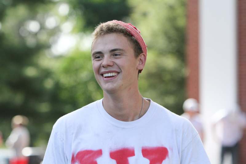 a man smiling with a red bandana on his head