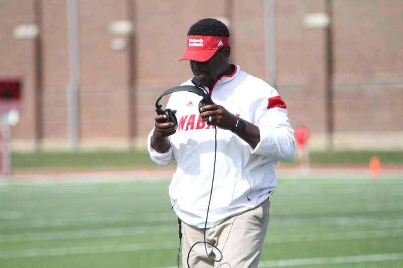 a man holding headphones on a field