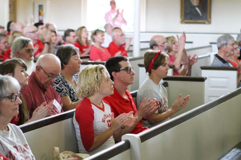 a group of people clapping in a church