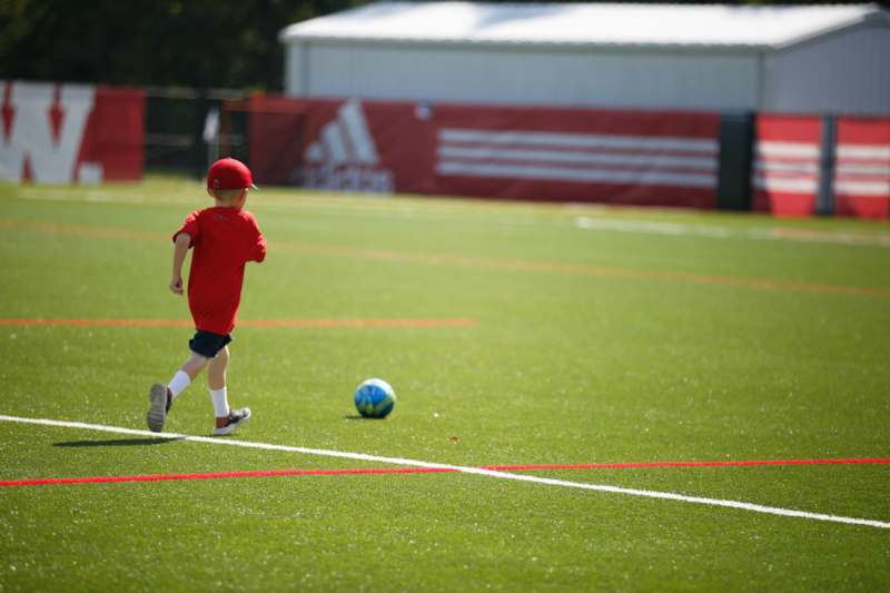 a boy running on a football field