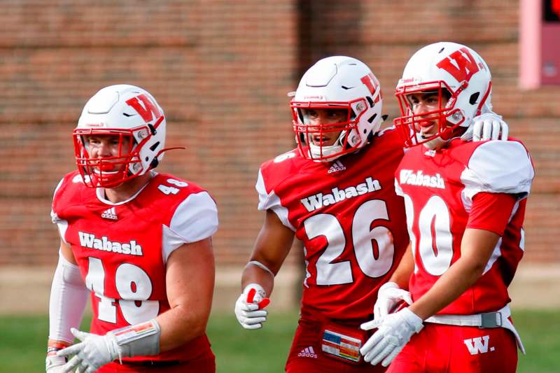 a group of football players wearing red and white uniforms