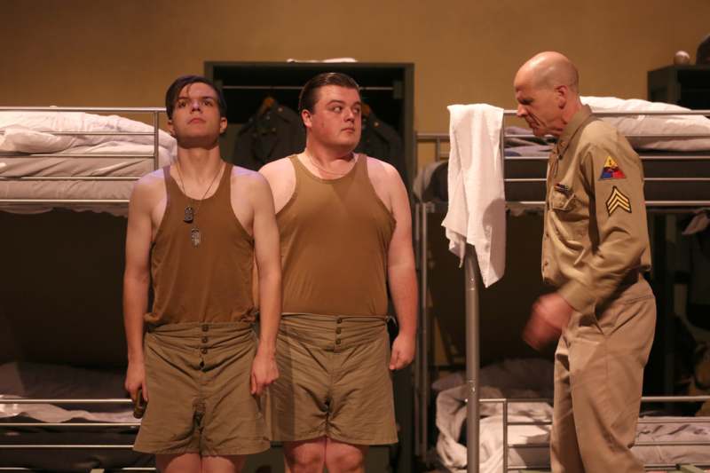 a group of men in tan tank tops