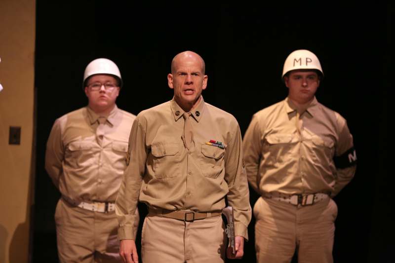 a group of men wearing tan uniforms