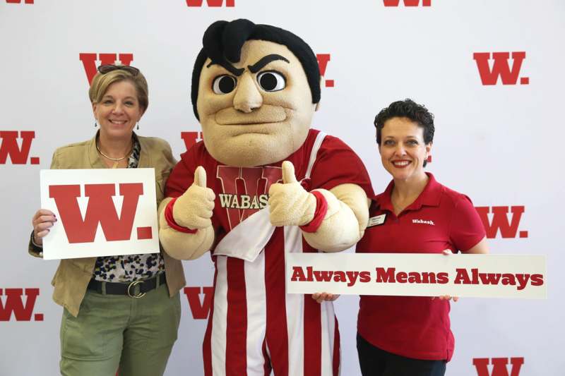 a group of women posing with a mascot