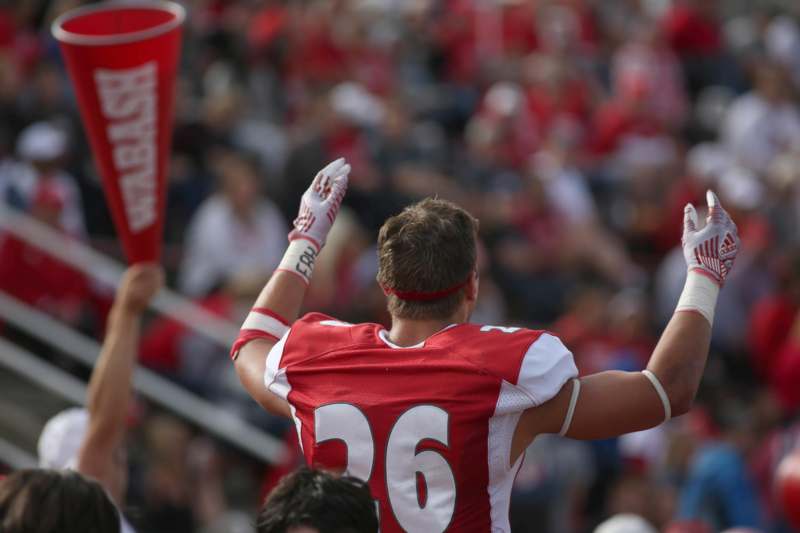 a football player raising his arms