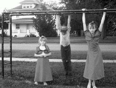 a group of children playing on a monkey bars