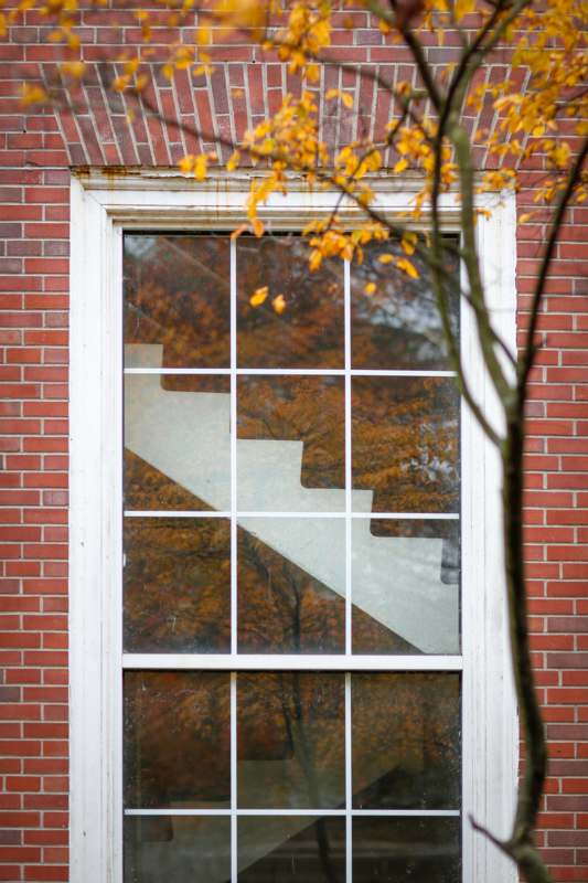 a window with a staircase in the background