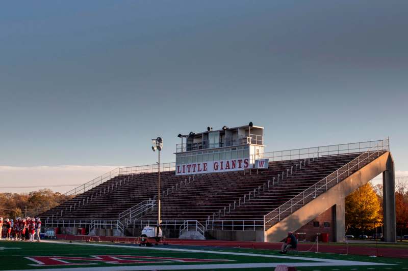 a stadium with bleachers and a sign