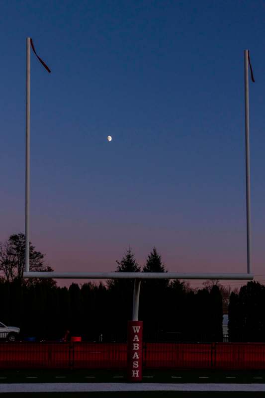 a football goal post with the moon in the sky