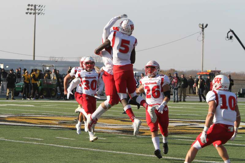 a group of football players jumping in the air