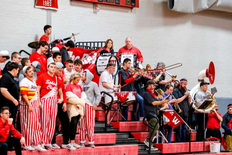 a group of people in red and white striped clothes playing instruments