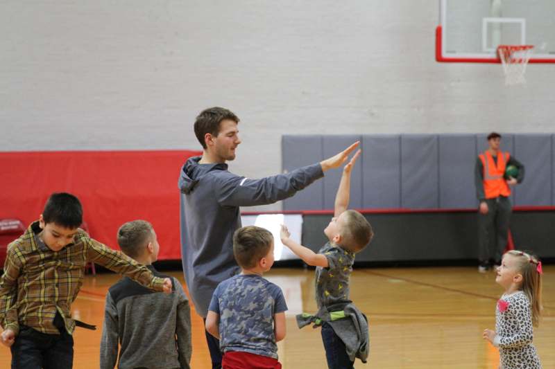 a man and kids in a gym