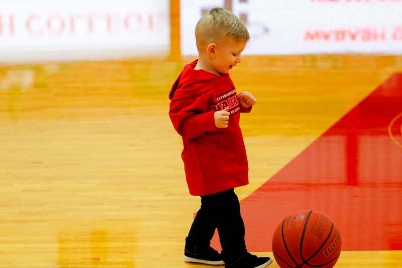 a child playing with a basketball