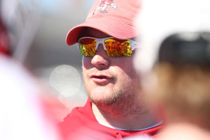 a man wearing sunglasses and a red hat