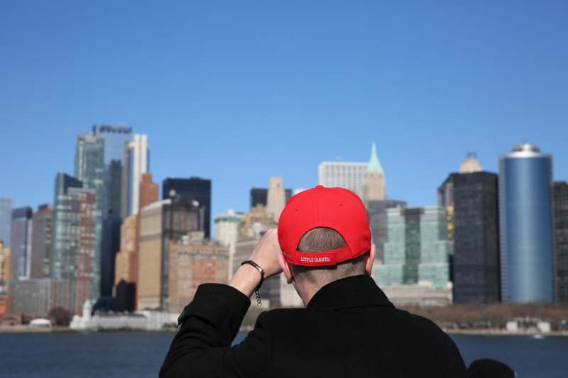 a man in a red hat looking at a city