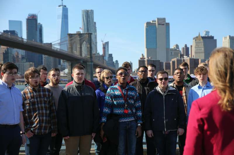 a group of people standing in front of a city