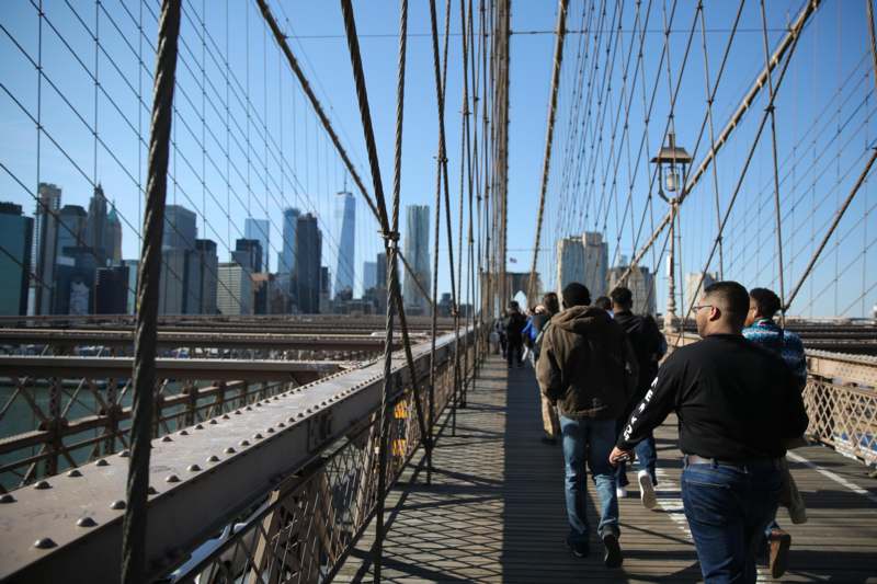 a group of people walking on a bridge
