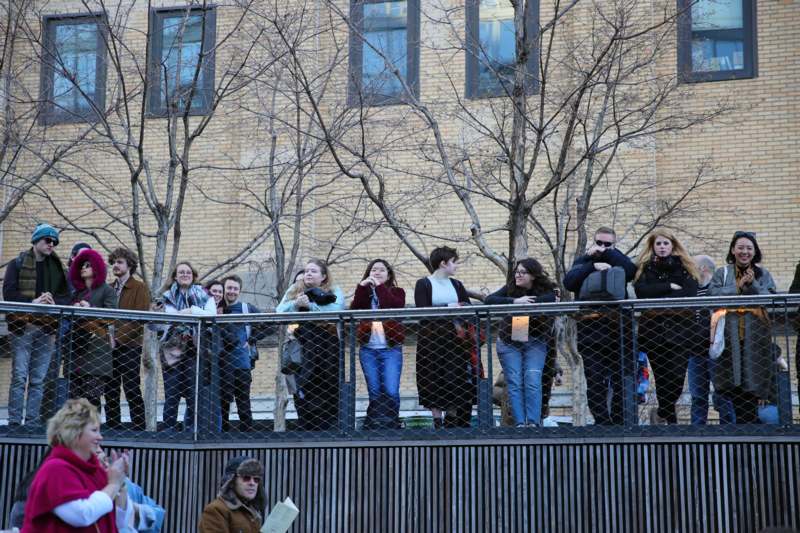 a group of people standing on a railing