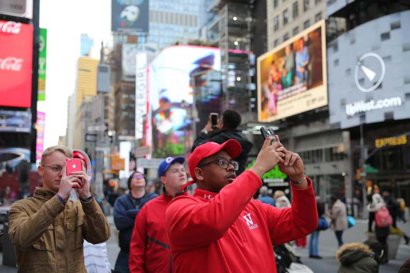 a man taking a picture of a crowd of people