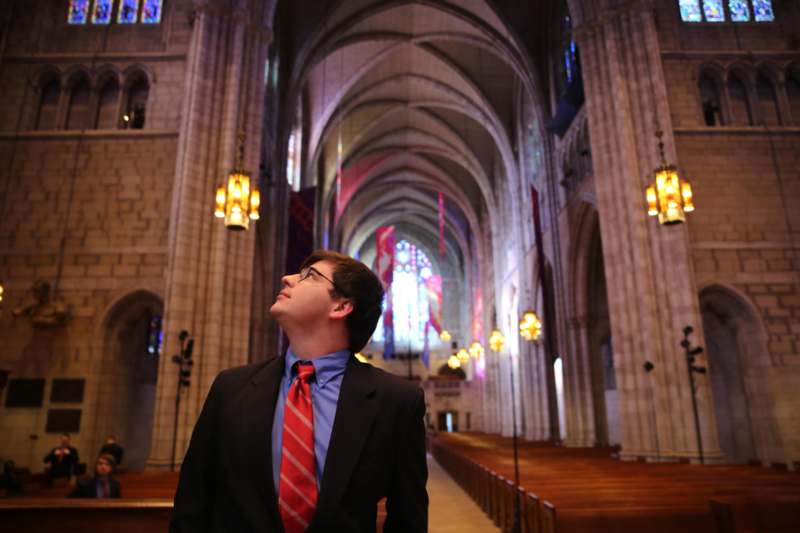 a man in a suit and tie in a church