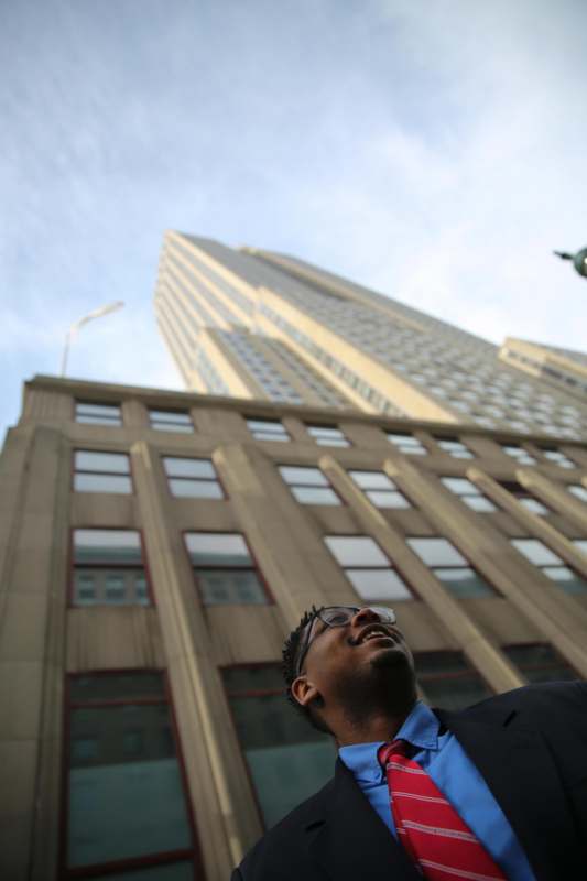 a man looking up at a tall building