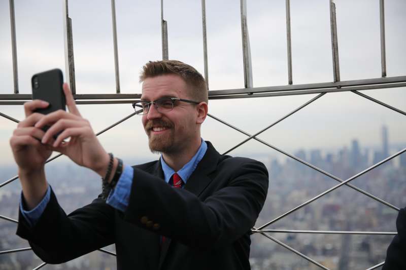 a man in a suit pointing up
