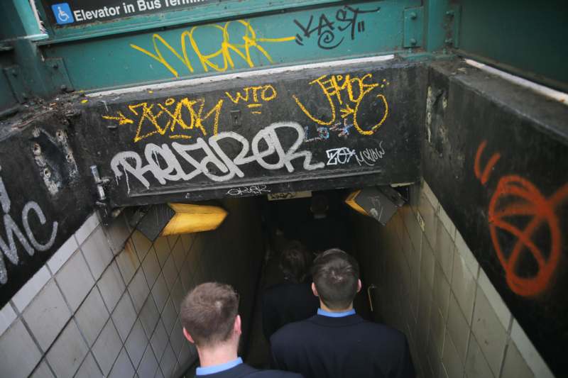 a group of people walking down a tunnel