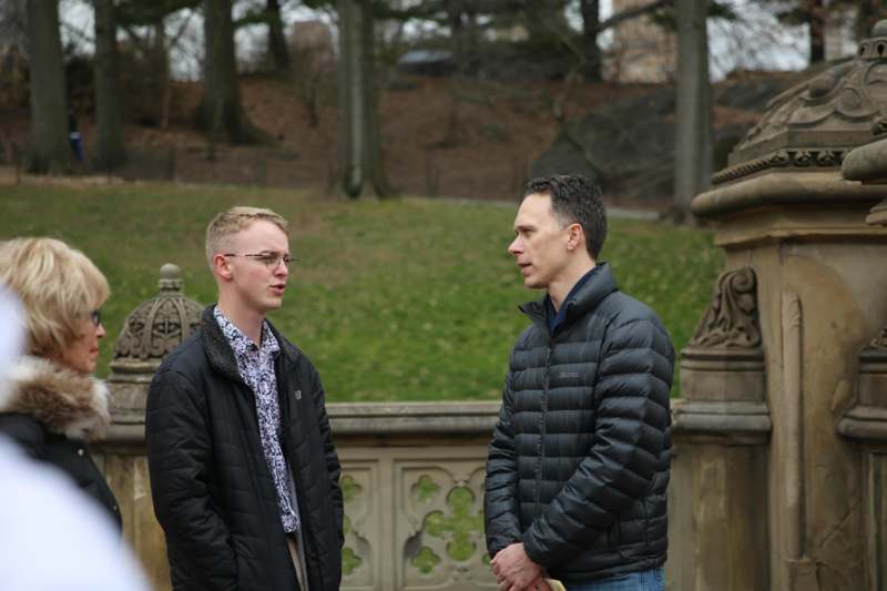 two men standing outside talking