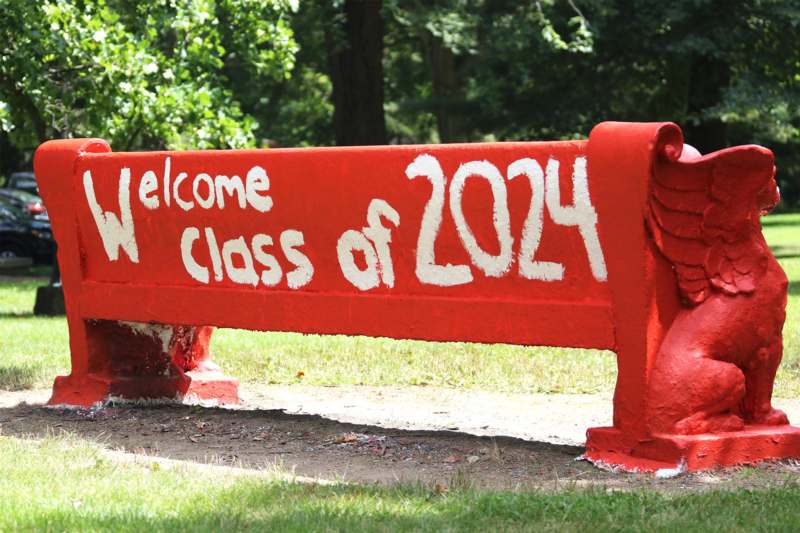 a red bench with white writing on it