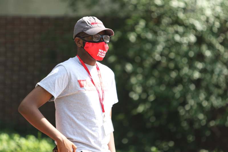 a man wearing a red face mask