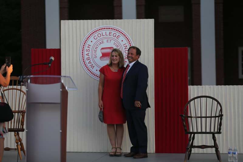 a man and woman standing in front of a podium