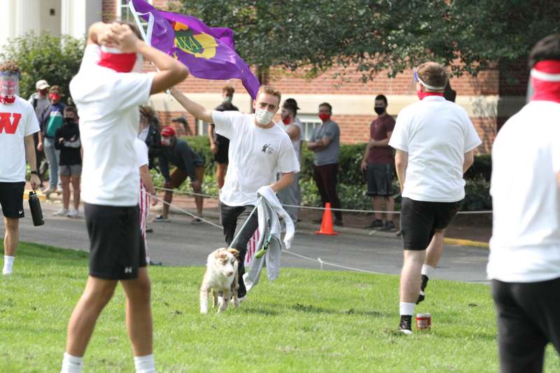 a group of people running with a dog