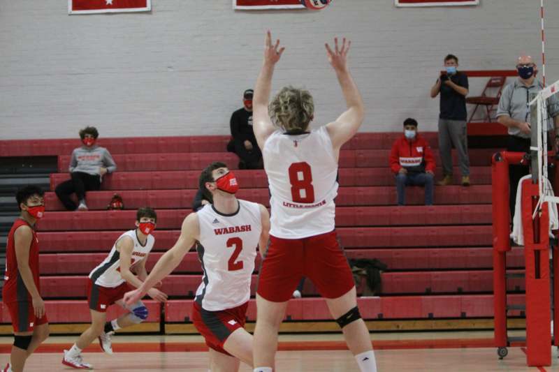 a group of people playing volleyball