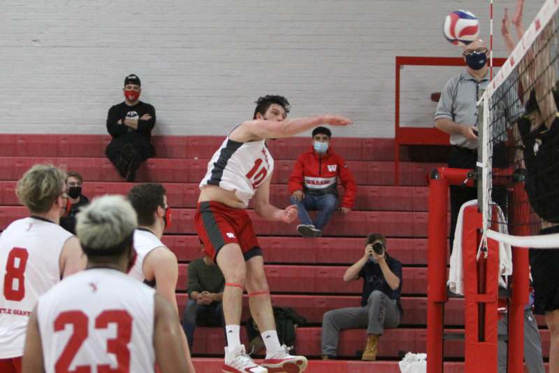 a man jumping in the air with a ball in front of him