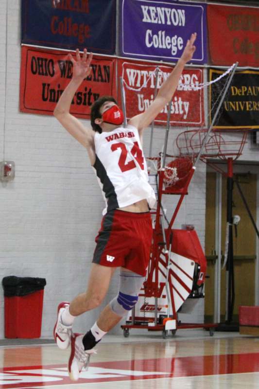a man jumping in the air with a mask on his face