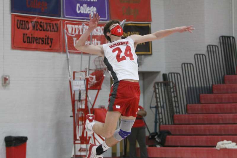 a man jumping in the air with a mask on