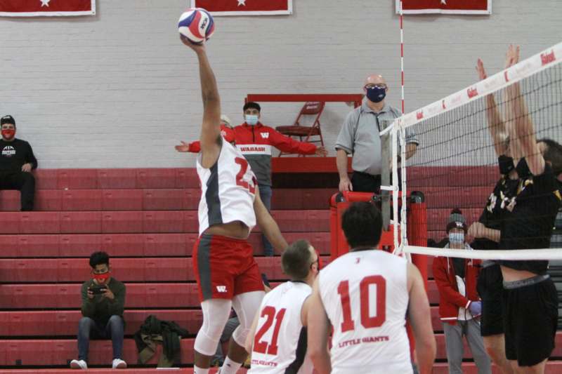 a group of people playing volleyball